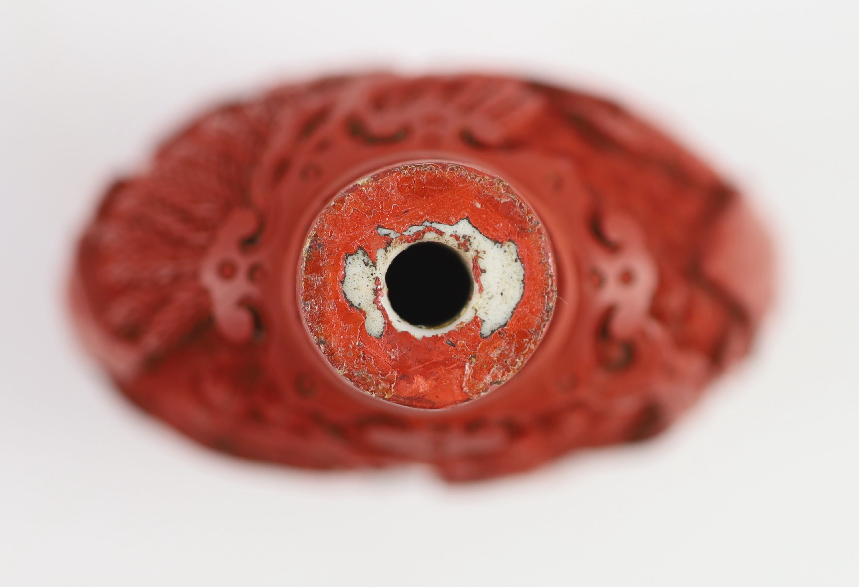 An unusual Chinese cinnabar lacquer on porcelain snuff bottle, 18th/19th century 6.2 cm high excluding stopper